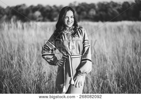 Pretty Young Brunette Girl In Long Embroidery Dress Outdoor