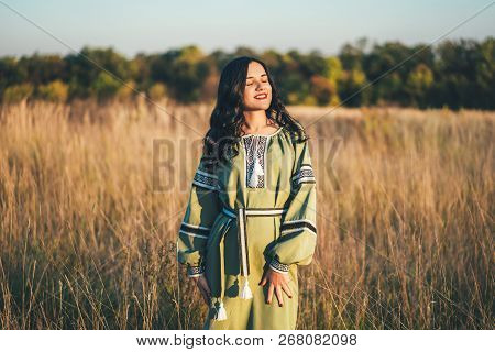 Pretty Young Brunette Girl In Long Embroidery Dress Outdoor