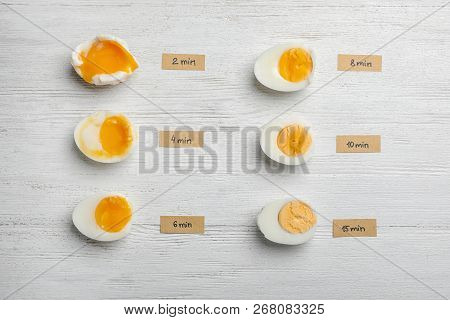 Various Types Of Boiled Eggs On White Wooden Background, Flat Lay. Cooking Time