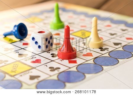 Multi-colored Game Chips With Dice On The Playing Board. Board Game.