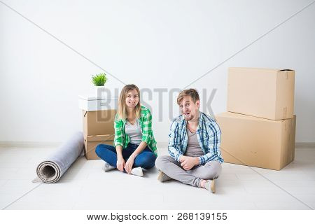 Relocation, Real Estate And Moving Concept - Young Cheerful Couple Moving Into Their New Home