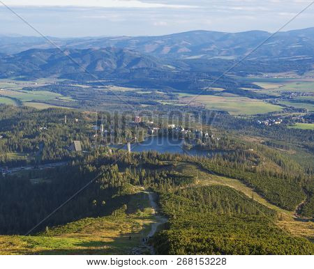 Aerial View On Strbske Pleso Village And Blue Mountain Lake From Chata Pod Soliskom With Forest, Hil