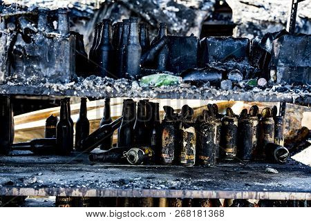 Close Up Damaged Supermarket Glass Plastic Bottles After Arson Fire With Burn Black Dark Debris Afte