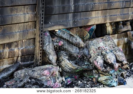 Close Up Damaged Supermarket Glass Plastic Bottles After Arson Fire With Burn Black Dark Debris Afte