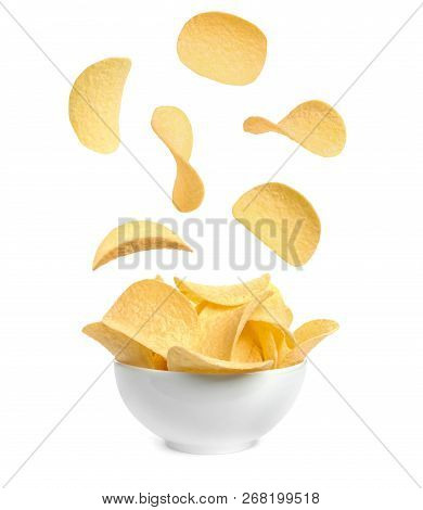 Tasty Potato Chips Falling Into Blow On White Background
