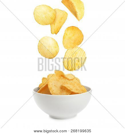 Tasty Potato Chips Falling Into Blow On White Background
