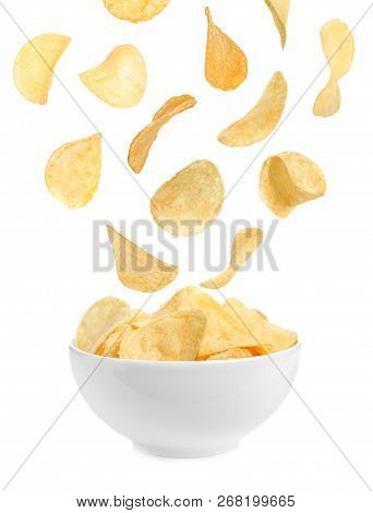 Tasty Potato Chips Falling Into Blow On White Background