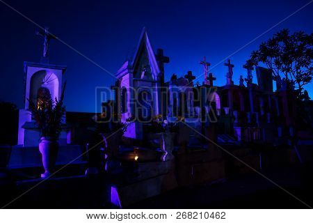 Merida, Cementerio General, Mexico - 31 October 2018: Dark Blue Lightened Tombstones With Buring Can