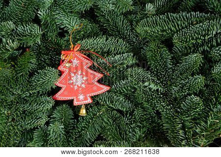 Christmas Background With Fresh Evergreen Tree Banches And Red Christmas Tree Decoration.