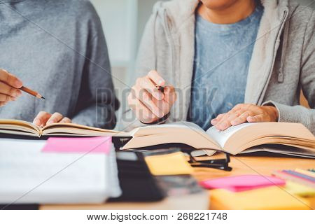 High School Or College Students Studying And Reading Together In Library