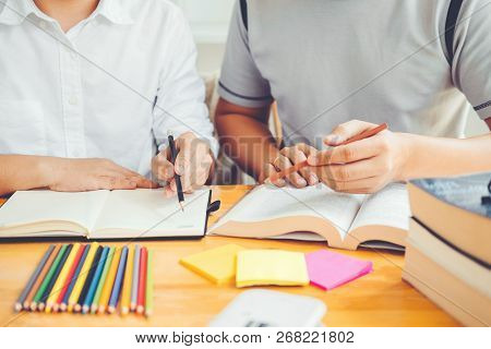 High School Or College Students Studying And Reading Together In Library