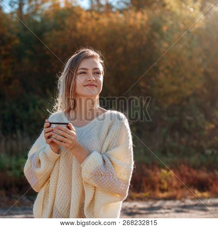 Beautiful Admiring Woman Drinking Hot Tea From Thermos Cup With Backligth Sun.