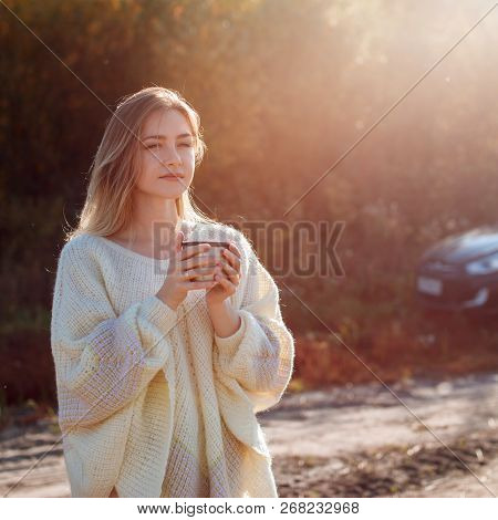 Beautiful Admiring Woman Drinking Hot Tea From Thermos Cup With Backligth Sun.