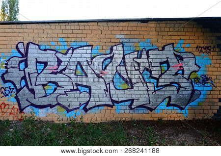 Full And Acomplished Graffiti Artwork. The Old Wall Decorated With Paint Stains In The Style Of Stre