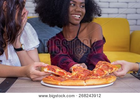 Friendship Enjoy Eating Pizza On A Table.