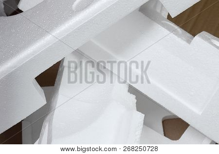 Background Image With Beige Cardboard Paper And Styrofoam Boxes Disgarded As Rubbish. The Concept Of