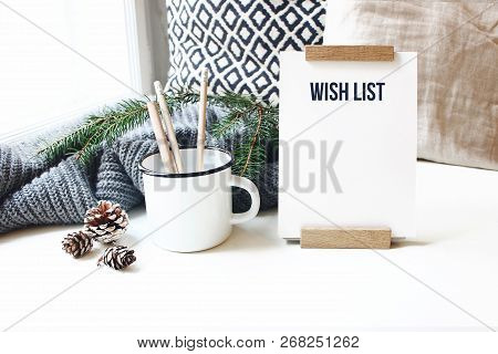 Winter Desktop Still Life Scene. Wish List Card, Board And Wooden Pencils In Mug Standing Near Windo