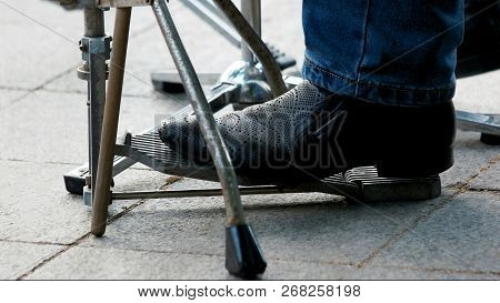 Foot Presses Musical Pedal Outdoor. Black Leather Male Perforated Shoes. Musician Feet. Drum Set On 