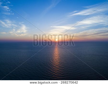 Aerial View Of A Sunset Sky Background. Aerial Dramatic Gold Sunset Sky With Evening Sky Clouds Over