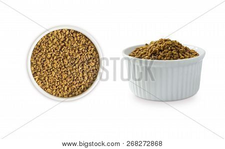 Fenugreek Seeds In A Wooden Bowl Isolated On White. Fenugreek Seeds Isolated On White Background. Fe