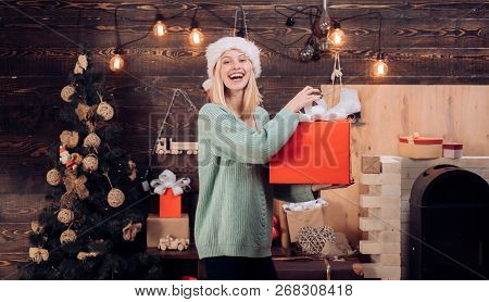 Happy Girl Preparing To Celebrate New Year And Merry Christmas. Christmas Tree On Home Wooden Backgr