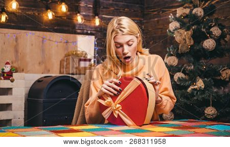 Surprised Woman With Christmas Gift. Happy Girl Preparing To Celebrate New Year And Merry Christmas.