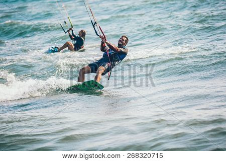 Professional Kiter Makes The Difficult Trick On A Beautiful Background. Kitesurfing Kiteboarding Act