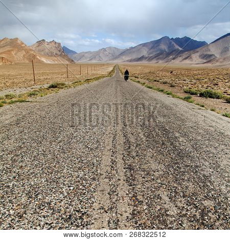 Pamir Highway Or Pamirskij Trakt With Biker, There Is One Of The Best Cycling Road On The World. Lan