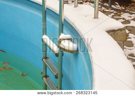 Stairs To The Pool And Dirty Water. A View Of The Pool In The Winter.