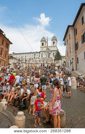 ROME - AUGUST 3: The Spanish Steps, with tourists, seen from Piazza di Spagna on August 3, 2018, Rome.The Spanish Steps are the widest staircase in Europe.