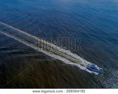 An Aerial Shot Of A Yacht Out On A Cruise, Speeding Toward Home At The End Of The Day.