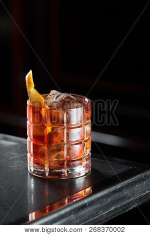 Boulevardie Cocktail On A Bar Desk. Black Background