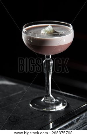 Porto Flip Cocktail On A Bar Desk. Black Background