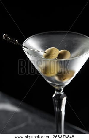 Dry Martini Cocktail On A Bar Desk. Black Background