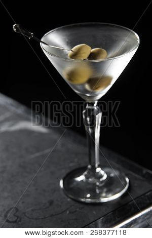 Dry Martini Cocktail On A Bar Desk. Black Background