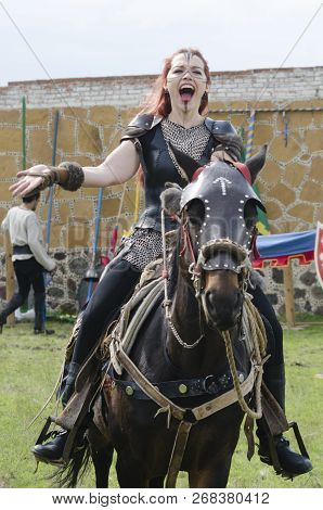 Tlaxcala, Mexico- September 29, 2018: Warrior Red-haired Woman Riding A Horse And Greeting At Audien