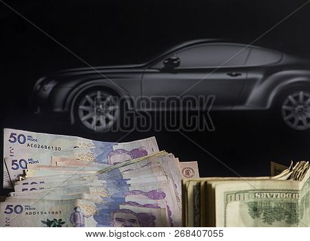 Project To Buy A Car- Colombian Dollars And Money With Black Car In The Background