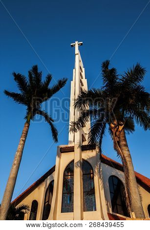 Community Catholic Church Front Entrnace Building View With Two Stained Glassed Windows. Tower Of A 