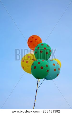Helium Balloons. Colorful helium balloons. Floating away in the blue sky. Birthday Balloons. Party Time.