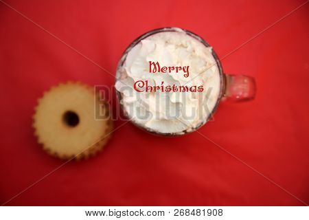 Hot Chocolate. Hot Coco in a glass mug with whip cream, cookies and text. Red Christmas background. Room for text