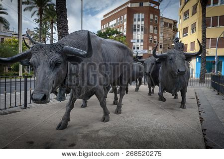 Editorial Alicante, Spain - October 14, 2018: Statues Of A Matador And Bulls Near The Plaza De Toros