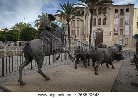 Editorial Alicante, Spain - October 14, 2018: Statues Of A Matador And Bulls Near The Plaza De Toros