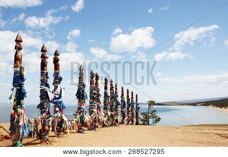 Vivid Colored Ribbons Hadak Tied On Posts Of Wish. Wooden Ritual Pillars. Sacred Place Of Buddhist S