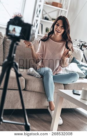 Modern Vlogger. Beautiful Young Woman Holding Beauty Products And Smiling While Making Social Media 