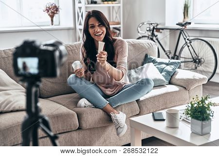 Giving Advice. Female Vlogger Making Social Media Video And Smiling While Sitting Indoors
