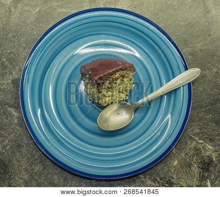 Marijuana Poppy Seed Cake With Chocolate And Fruit Glaze On Blue Plate