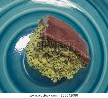 Marijuana Poppy Seed Cake With Chocolate And Fruit Glaze On Blue Plate