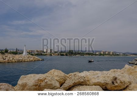 Zygi, Cyprus - June 16, 2018:dingy Boat Entering The Harbour At Zygi, Cyprus. The Entrance Is Lined 