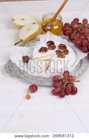 Camembert With Honey, Pear And Grapes And Walnuts