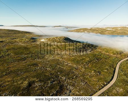 Aerial View. Road Crossing Hardangervidda Mountain Plateau, Clouds Over Lakes, Morning Time. Norway 